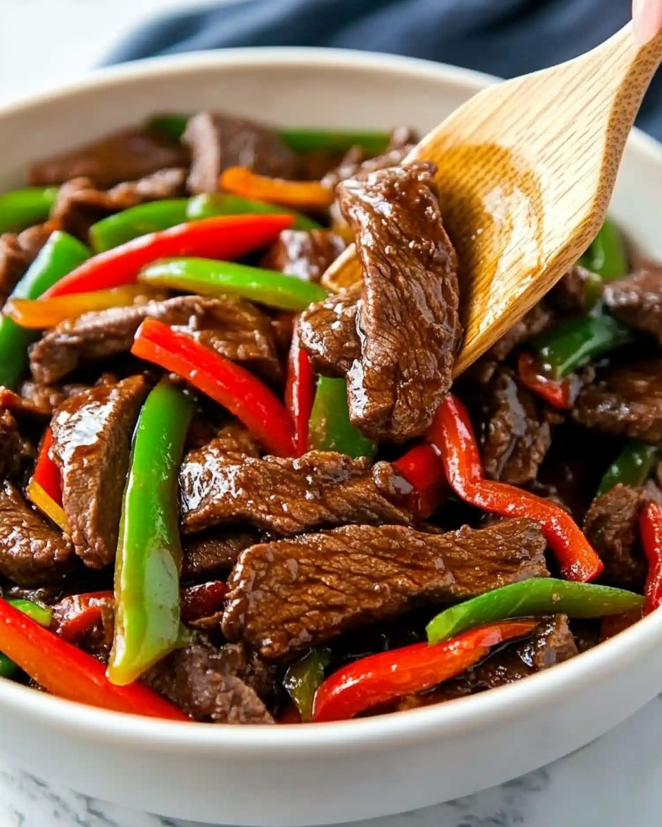 The image shows a white bowl filled with a base layer of white rice. On top of the rice, there is a layer of cooked beef strips that are dark brown and shiny with sauce. Scattered around and mixed within the beef are long slices of green and red bell peppers, adding bright green and red colors to the dish. The bowl sits on a white marbled surface, and a blurred blue and white cloth can be seen in the background. Photo taken with an iphone --ar 4:5 --v 6.1
