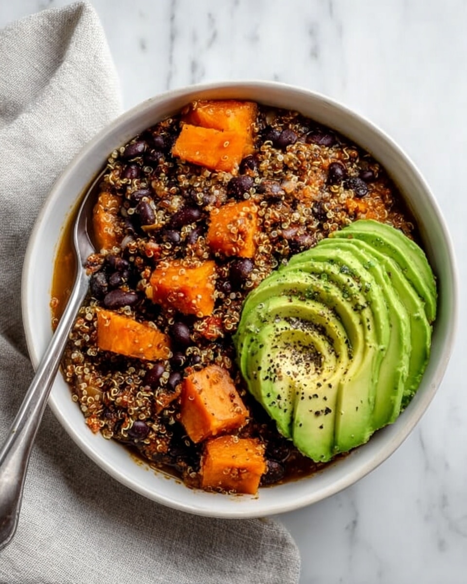 The image shows a white ceramic bowl filled with several layers of food. The bottom layer is a mix of red-orange quinoa and black beans, giving a grainy and rich texture. On top of this, there are chunks of orange sweet potato scattered around. Sitting on one side, there are slices of green avocado layered neatly. In the center, there is a dollop of white cream sauce sprinkled with small chopped green herbs. Light yellow shredded cheese is spread over the dish, and small leaves of cilantro are scattered on top for garnish. The bowl is placed on a white marbled surface, and a spoon rests inside it. Around the main bowl, there are other bowls of the same food, along with a small bowl of creamy sauce. Photo taken with an iphone --ar 4:5 --v 7
