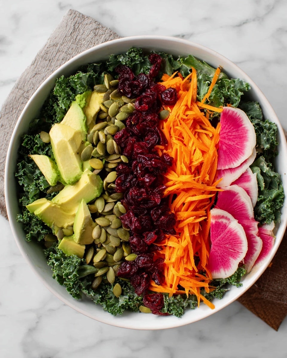 A white bowl filled with a kale salad sits on a white marbled surface. The bottom layer is dark green kale leaves, rough and curly, covering the entire bowl. On top, there are five neat rows of different toppings: pale green avocado chunks on the left, bright orange shredded carrots next to it, deep red grated beets in the middle, light green pumpkin seeds to the right of the beets, and round pink watermelon radish slices with a white edge on the far right. Scattered dried red cranberries add small dark spots throughout the layers. Photo taken with an iphone --ar 4:5 --v 7