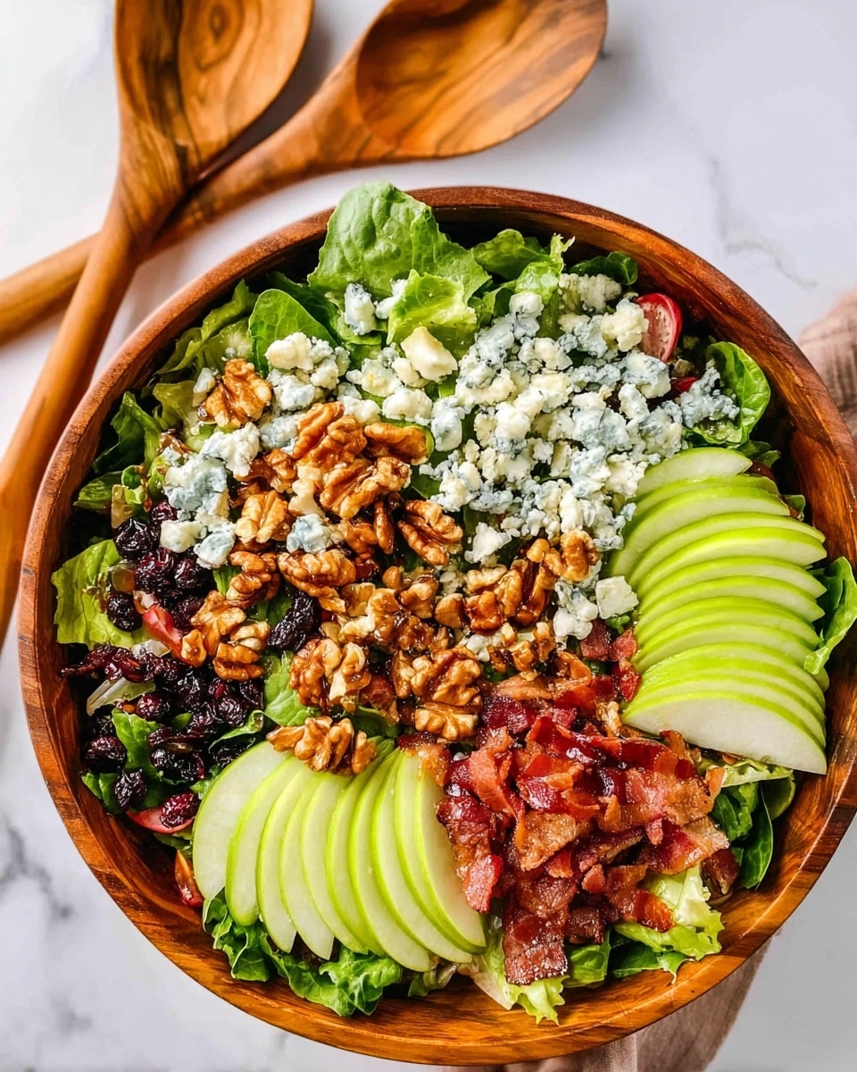 A large wooden bowl filled with a fresh salad; the base layer is a mix of dark green and light leafy greens spread evenly. On top, there are three sections of thin green apple slices placed upright and close together. Around the apples, crumbled blue cheese pieces are scattered all over. On two opposite sides, there are clusters of brown walnuts with a shiny glaze. Crispy bacon strips and small bacon pieces are layered next to the apples and walnuts, adding texture and reddish-brown color. The bowl sits on a white marbled surface, with two wooden spoons placed in the background. Photo taken with an iphone --ar 4:5 --v 7