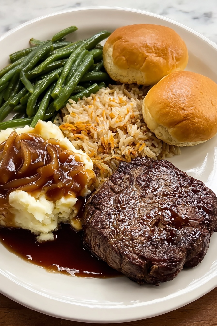A white plate shows a meal with four main parts: in the front right, a thick, dark brown grilled steak with a shiny, juicy surface; behind the steak, two golden brown, fluffy biscuits with light crispy tops; to the left of the biscuits, a pile of green beans, steamed with a smooth texture and a deep green color; next to the green beans and toward the left edge of the plate, creamy mashed potatoes covered partly with rich brown gravy that slightly spreads onto the plate. The plate sits on a white marbled surface. Photo taken with an iphone --ar 4:5 --v 7
