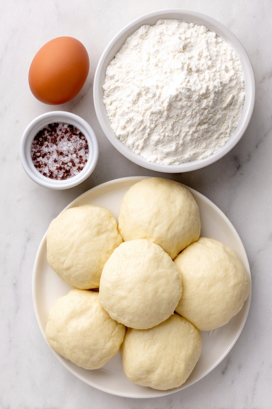Easy Soft Pretzel Bites Recipe 7 Flat lay of one whole uncracked brown egg, a small white ceramic bowl filled with coarse salt crystals, a small white ceramic bowl containing baking soda powder, and several smooth balls of pale biscuit dough arranged symmetrically on a simple white ceramic plate, placed on a clean white marble surface, soft natural light, photo taken with an iPhone, professional food photography style, fresh ingredients, white ceramic bowls, no bottles, no duplicates, no utensils, no packaging --ar 2:3 --v 7 --p m7354615311229779997 - Easy Soft Pretzel Bites, soft pretzel bites, homemade pretzel snacks, quick pretzel bites, salty pretzel bites