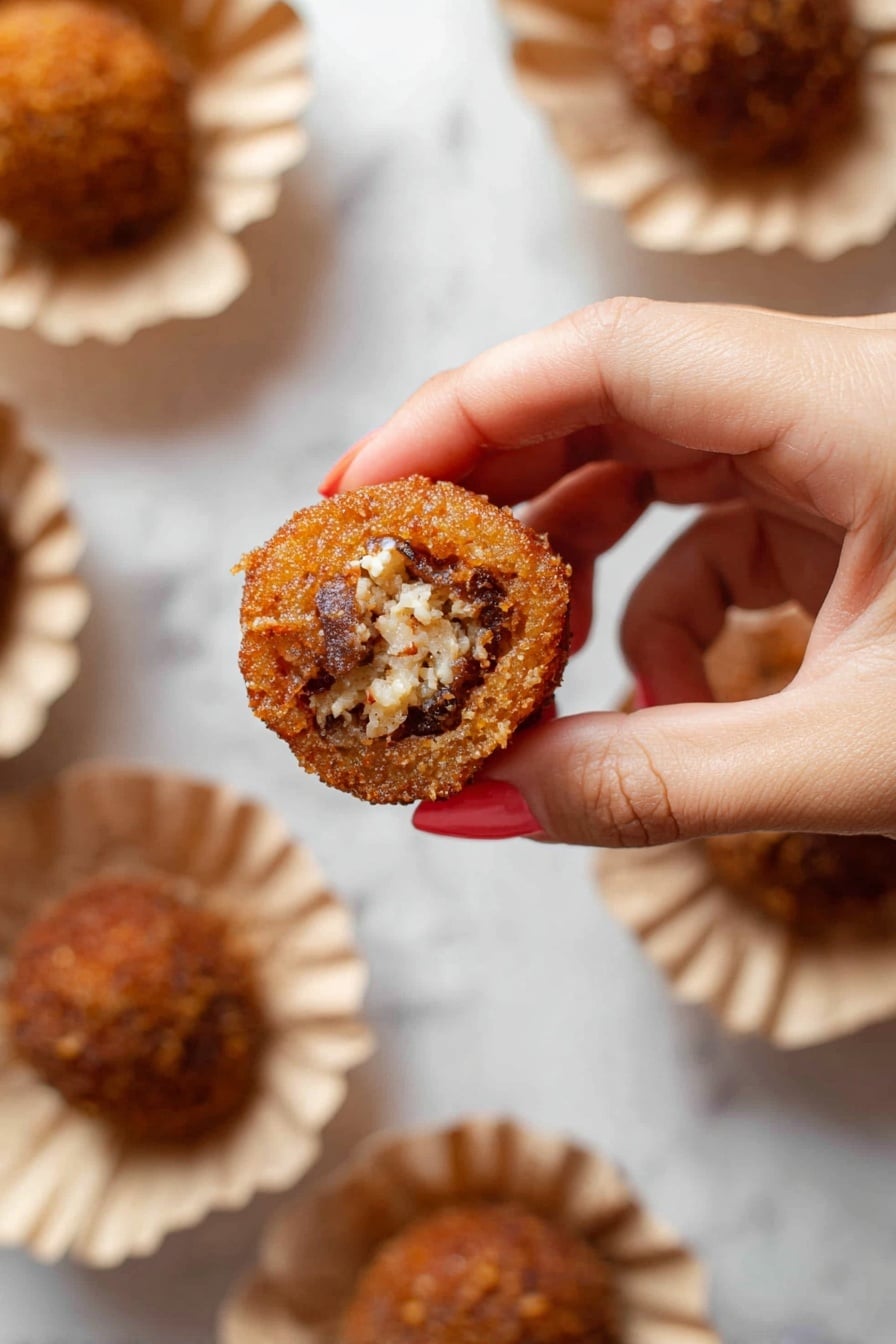 Authentic Pani Puri Recipe 6 A close-up of a woman's hand holding a small round fried snack with a crispy brown outer shell that is textured and thin. Inside the snack is a filling with visible white and dark brown chunks, appearing soft and crumbly. The snack is held above white paper bowls that hold more of the same items, placed on a white marbled surface. The bowls have a gathered edge and the snacks in them look similar in color and texture to the one held. photo taken with an iphone --ar 2:3 --v 7 - Authentic Pani Puri, Pani Puri recipe, Indian street food, How to make pani puri, Crispy puris and tangy jaljeera