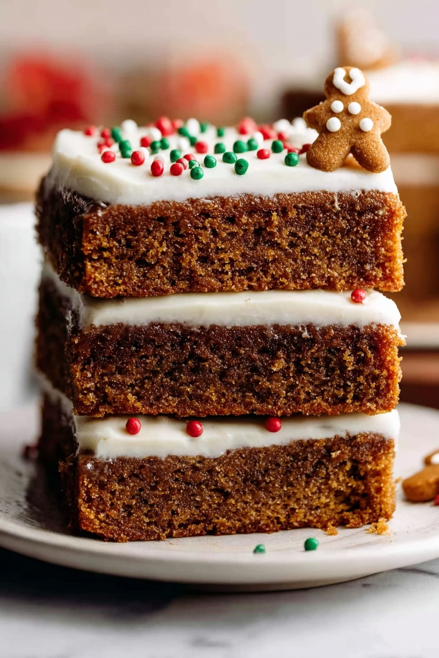 Gingerbread Cookie Bars with Cream Cheese Frosting Recipe 8 A stack of three thick, soft brown cake layers with a moist texture sits on a white plate placed on a white marbled surface. The top layer is covered with smooth white frosting, decorated with small round red, green, and white sprinkles, and a few small gingerbread-shaped decorations on the right side. The background is blurred with warm colors, making the cake the clear focus. photo taken with an iphone --ar 2:3 --v 7 - Gingerbread Cookie Bars with Cream Cheese Frosting, gingerbread dessert, holiday cookie bars, spicy gingerbread bars, easy gingerbread treats