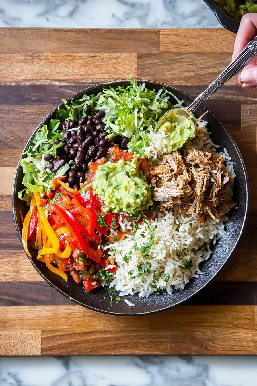 Instant Pot Carnitas Burrito Bowls Recipe 6 This image shows a white bowl filled with a colorful layered salad on a white marbled surface. The bottom layer is chopped green lettuce, topped with a layer of white rice. On top of the rice, there is a spread of dark brown shredded meat placed on one side. Next to the meat, there are yellow corn kernels and black beans mixed with chopped red tomatoes, onions, and green herbs. Shredded white cheese is sprinkled over the vegetables. A large dollop of green guacamole sits on one side of the bowl, and a white creamy sauce is placed beside it. A silver spoon is resting on the edge of the bowl. A white and black striped cloth is beside the bowl. Photo taken with an iphone --ar 2:3 --v 7 - Instant Pot Carnitas Burrito Bowls, Mexican burrito bowl recipe, effortless carnitas dinner, easy Instant Pot Mexican dish, family-friendly burrito bowl