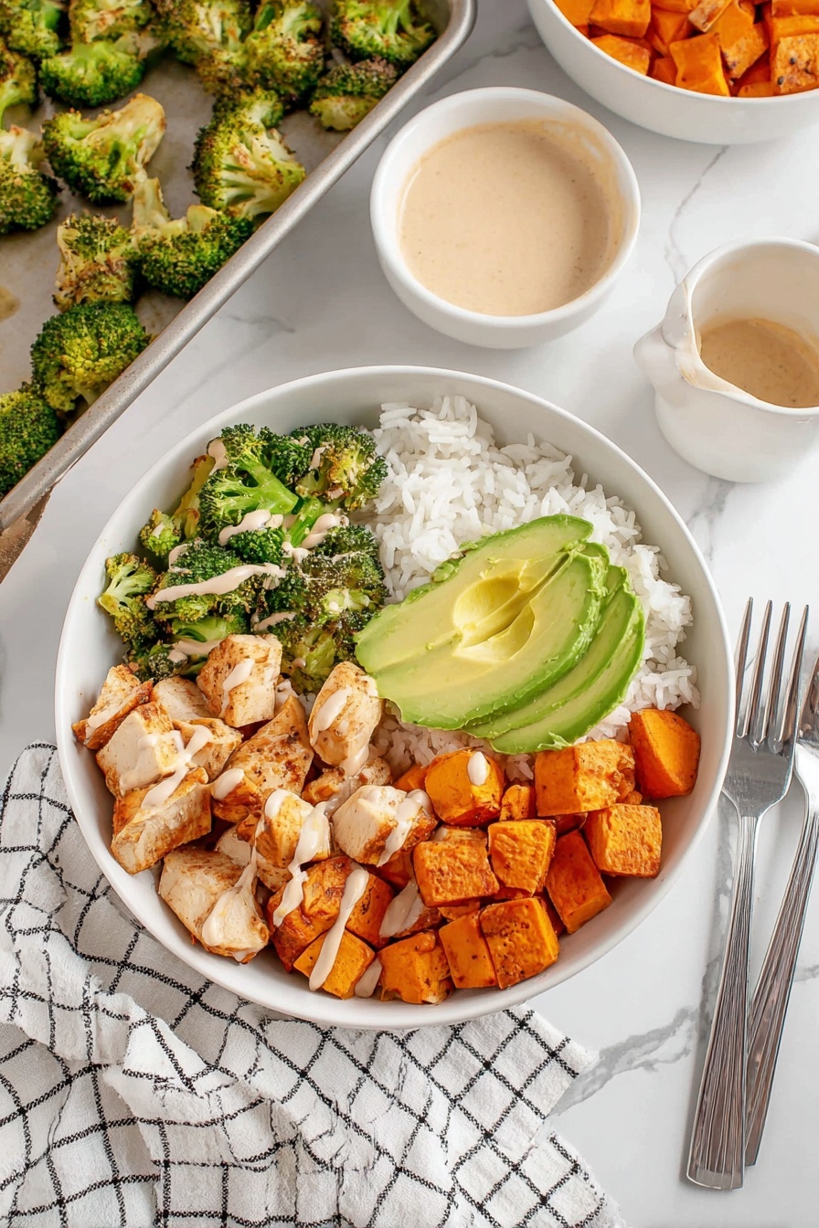 Cajun Chicken Sweet Potato Rice Bowl Recipe 8 A white bowl filled with three main layers: white rice at the bottom on the left side, roasted orange sweet potato cubes on the right, and golden-brown cooked chicken pieces in the center. On top and to the left, there are green roasted broccoli florets, some drizzled with a light brown creamy sauce. Sliced avocado with bright light green hues sits above the broccoli. The bowl is set on a white marbled surface with a white and black checkered cloth nearby, holding three silver forks. A white bowl of light brown creamy sauce, raw sweet potatoes, and a baking tray with roasted broccoli are also visible in the background. Photo taken with an iphone --ar 2:3 --v 7 - Cajun Chicken Sweet Potato Rice Bowl, Cajun Chicken dinner ideas, healthy rice bowl recipes, spicy chicken and sweet potato bowls, easy dinner recipes
