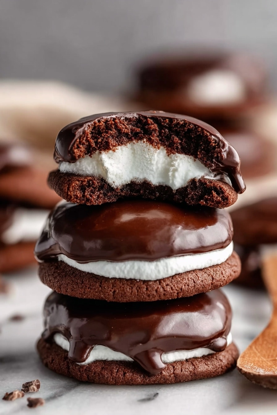 Marshmallow Hot Cocoa Cookies Recipe 6 The image shows a stack of three chocolate cookies on a white marbled surface, each cookie covered with a smooth, shiny layer of dark chocolate on top. The top cookie is broken in half and placed on top of the stack, revealing a soft white marshmallow filling inside with a slightly melted texture. The middle and bottom cookies are whole, and the dark chocolate tops look glossy and thick. In the background, there are blurred more cookies and a woman’s wooden spoon partially visible. The overall color palette is rich brown with white marshmallow, and the focus is sharp on the cookie stack. photo taken with an iphone --ar 2:3 --v 7 - Marshmallow Hot Cocoa Cookies, hot cocoa cookies, chocolate marshmallow cookies, cozy dessert recipes, easy holiday cookies