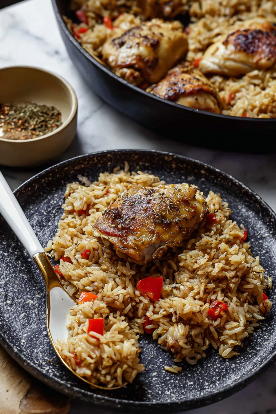 Jerk Chicken and Rice Recipe 6 The image shows a close-up of a dark speckled plate holding a serving of cooked rice mixed with small pieces of red bell pepper, along with two browned pieces of chicken on top. The rice is a light brown color with a slightly oily texture, and the chicken has a crispy, golden-brown skin with visible seasoning and herbs. A white and gold spoon rests on the plate, scooping up some rice. In the background, there is a black pan filled with more rice and chicken, along with a small beige bowl containing a spice mix. The setting is on a white marbled surface, giving a clean and simple look. photo taken with an iphone --ar 2:3 --v 7 - Jerk Chicken and Rice, Jamaican jerk chicken, Caribbean rice dish, spicy jerk chicken recipe, flavorful dinner ideas