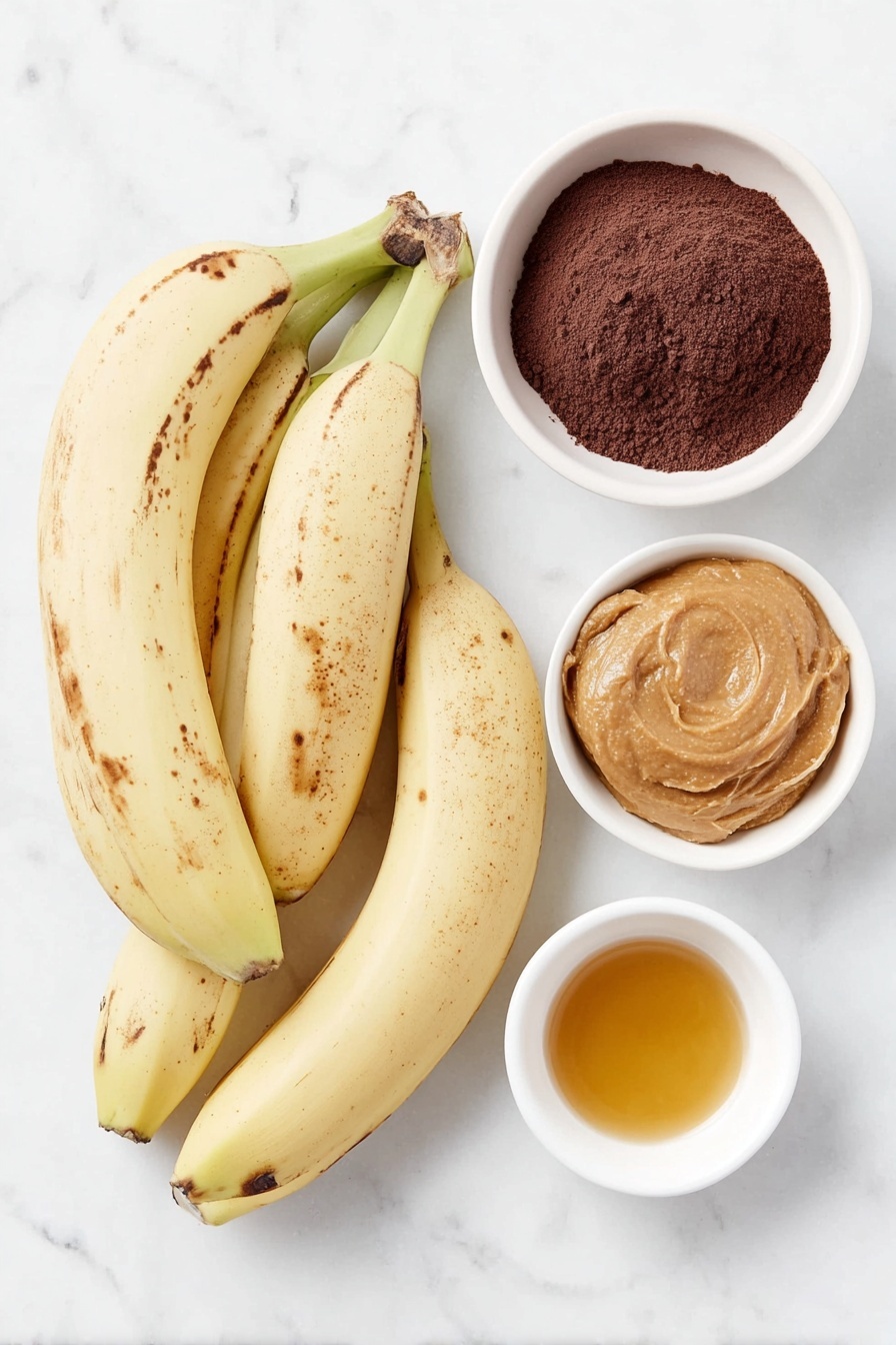 3-Ingredient Banana Brownies Recipe 7 Flat lay of three medium overripe bananas with a few brown spots, a small white ceramic bowl filled with smooth peanut butter, a small white ceramic bowl containing fine unsweetened cocoa powder, and a small white ceramic bowl holding golden maple syrup, all arranged symmetrically with balanced spacing, placed on a clean white marble surface, soft natural light, photo taken with an iPhone, professional food photography style, fresh ingredients, white ceramic bowls, no bottles, no duplicates, no utensils, no packaging --ar 2:3 --v 7 --p m7354615311229779997 - 3-Ingredient Banana Brownies, easy banana brownies, healthy banana brownie recipe, quick banana dessert, simple vegan brownies